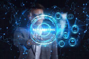 Fototapeta premium Business, technology, internet and network concept. Young businessman thinks over the steps for successful growth: Remarketing