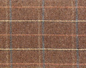 Expensive men's suit. Virgin wool extra fine. Brown with light blue cross. Glenurquhart check is made of cashmere fabric. Traditional Scottish Glen plaid