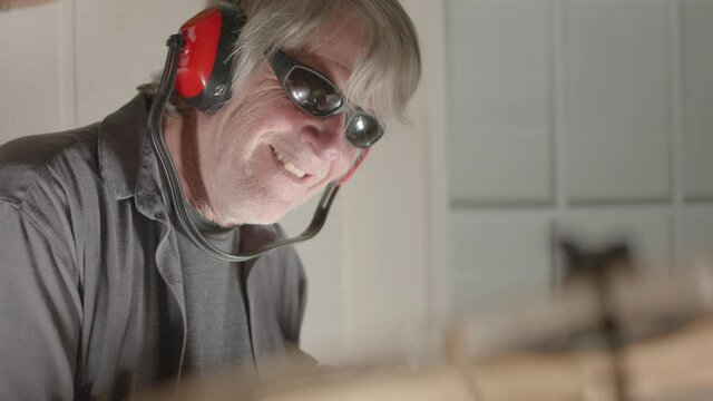 Adult Man With Grey Hair Acting Silly While Playing Drums - Shallow Depth Of Field