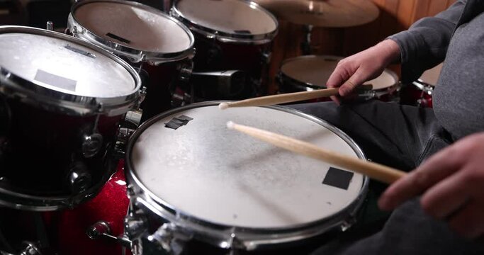 Red drumset snare drum played in slow motion .