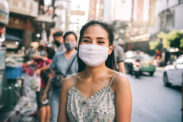 Portrait happy asian adult woman wear mask on face protect virus corona or covid 19