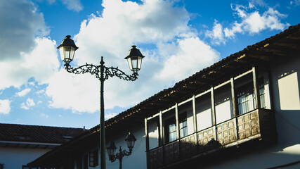 Old spanish architecture in cusco with a lamp post during sunset