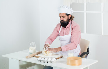 bearded guy cook preparing food in home kitchen, cook