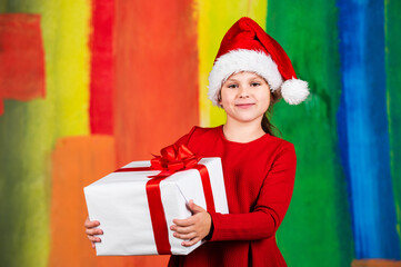 Winter holidays. Little girl hold gift box. Kid hold present box colorful background. Xmas gift shopping. Family tradition. Beautiful gift package. Give away. Merry Christmas and happy holidays