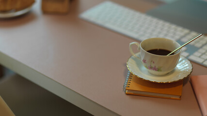 Coffee cup on computer table with copy space and supplies
