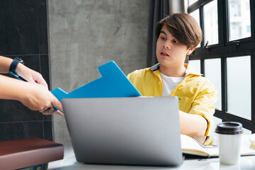 Asian businessman talking to partner about financial report.