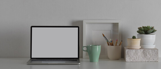 Workspace with mock up laptop computer and office supplies, clipping path