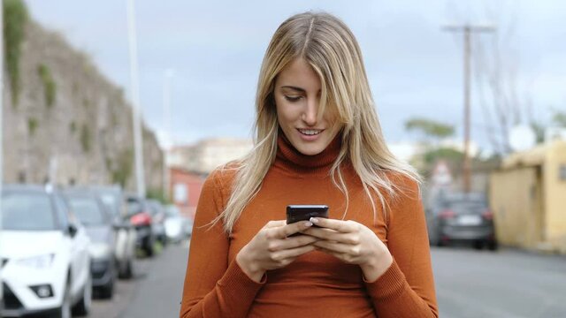 social, technology - beautiful girl reads a post on facebook and smiles 