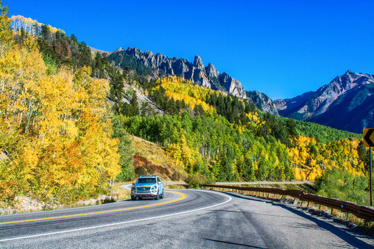 car on mountain road in autumn