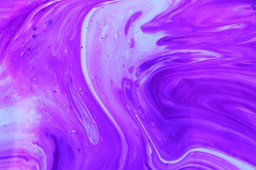 Abstract lilac marble background. Acrylic paint flows freely and creates an interesting pattern....