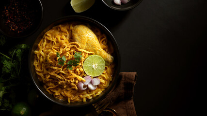 Northern Thai food, Noodles curry soup with Chicken (Khao Soi) serving in restaurant