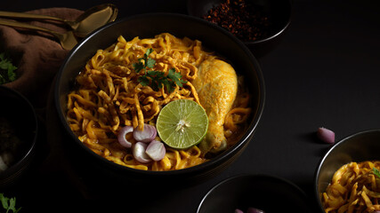Northern Thai food, Noodles curry soup with Chicken (Khao Soi) serving in restaurant