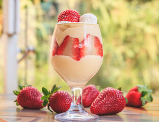 Bowl with cream and whipped cream with strawberries