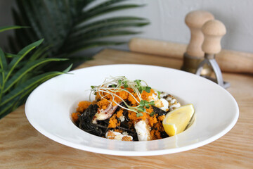 Black spaghetti pasta with seafood, tomatoes and basil