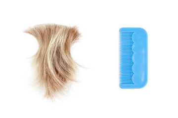 Blond lock of hair & blue plastic comb on white background isolated close up, cut off natural...