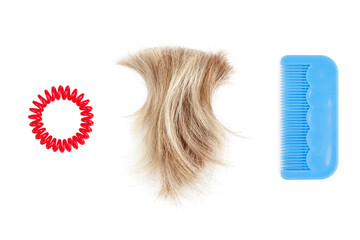 Blond lock of hair, red scrunchie, blue plastic comb white background isolated close up, cut off blonde hair curl, hair brush, spiral hair band barrette, hairstyle accessory set, coiffure tool, hairdo