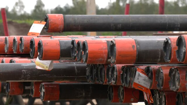Drill Pipe Stacked on Pipe Deck. Oilfield Production Tubing Bundles on The Main Deck of Drilling Rig
