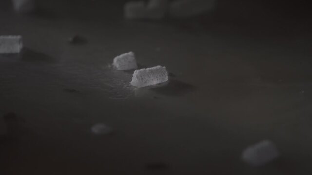 A piece of dry ice create smoke when in contact with a liquid