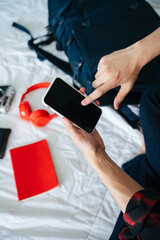 Asian man looking at map on digital smartphone for travel trip.