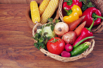 Fresh appetizing vegetables on a wooden table.