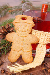 Glass of mulled wine wrapped scarf, gingerbread, spices and spruce branches