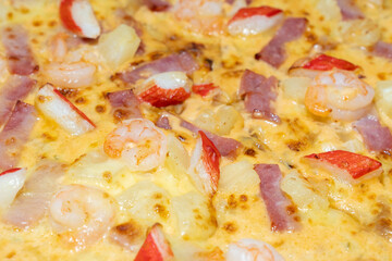 Cover pizza with seafood, ham, shrimp, crab sticks and pineapple, Thailand.