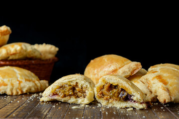 Beef Empanada fill close up. Wooden background.