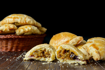 Beef Empanada fill close up. Wooden background.