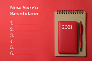 Notebooks with pen and empty list of New Year resolution on color background
