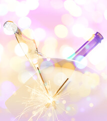 Composition with splashing champagne in glass, bottle and clock on color background