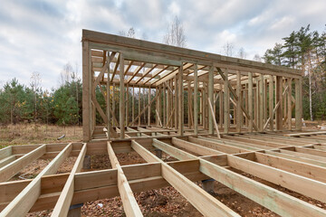 Construction of a frame house in the forest. Autumn