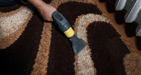 the process of cleaning the carpet with a washing vacuum cleaner
