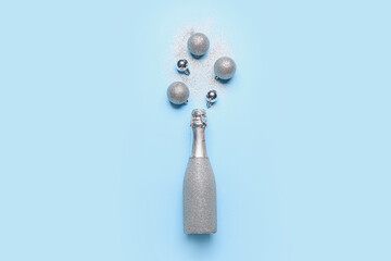 Christmas composition with bottle of champagne on color background