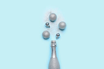 Christmas composition with bottle of champagne on color background