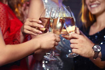 Young people drinking tasty champagne at party in nightclub