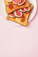Tasty sandwiches with sweet fig jam on color background