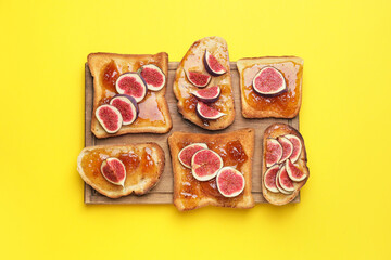 Tasty sandwiches with sweet fig jam on color background