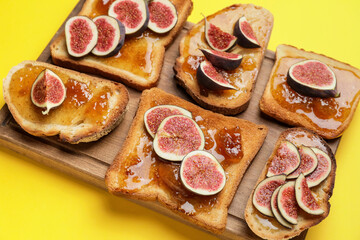 Tasty sandwiches with sweet fig jam on color background