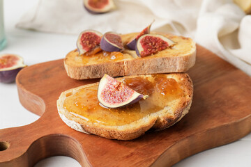 Tasty sandwiches with sweet fig jam on table, closeup