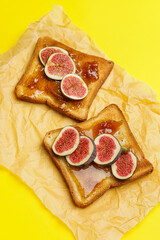 Tasty sandwiches with sweet fig jam on color background