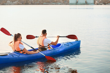 Young couple kayaking in river