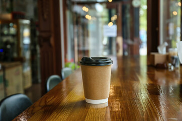Cup of hot coffee on table in cafe