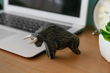 Figurine of bull as symbol of year 2021 on table in room