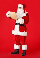 Santa Claus with letter on color background