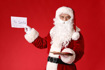 Santa Claus with letters on color background