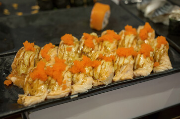 Japan food, Salmon Lava Roll in black plate, focus selective.