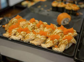 Japan food, Salmon Lava Roll in black plate, focus selective.