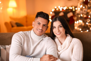 Happy young couple celebrating Christmas at home