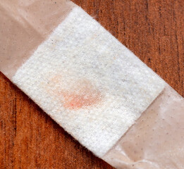 Close-up of medical adhesive plaster with blood.