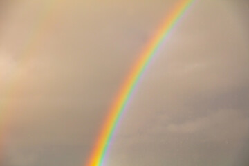 Rainbow in the sky against the background of clouds.